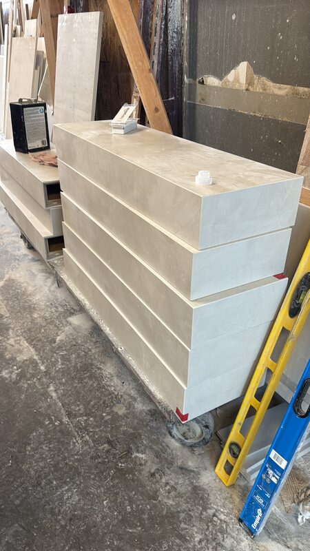 Fabricated porcelain tread boxes with mitred edges stacked before installation