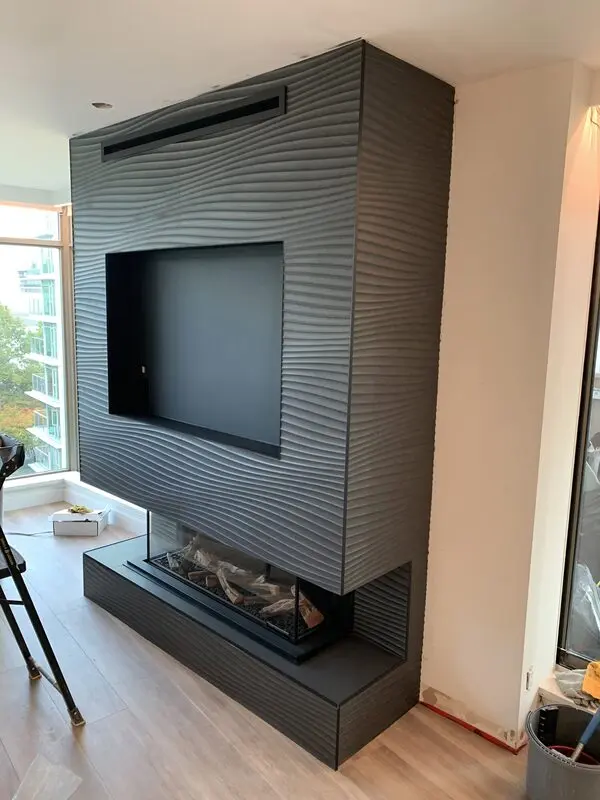 Fluted stone fireplace surround with crisp mitred corners and a floating hearth