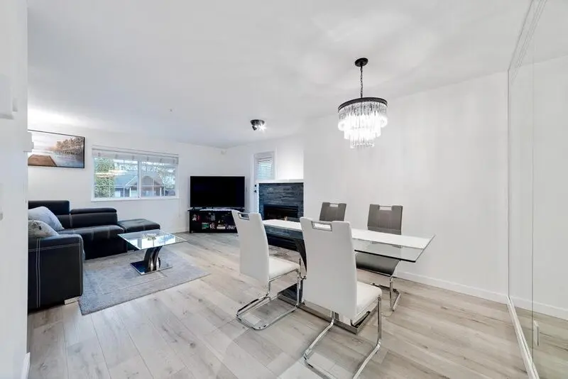 Open-plan living and dining area with continuous engineered hardwood flooring